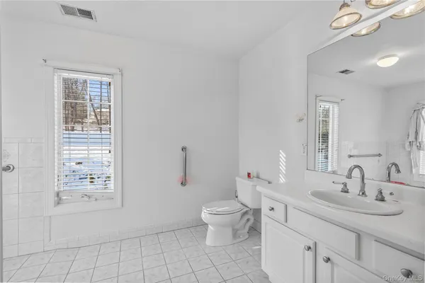a bathroom with a sink toilet and a mirror