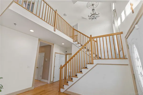 a view of staircase with lots of frames and a wooden floor