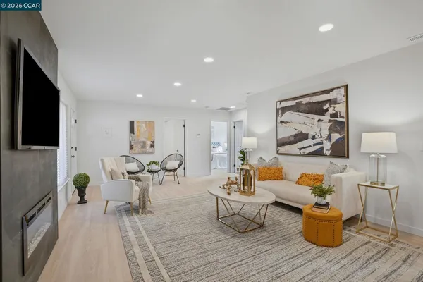 a living room with furniture and wooden floor