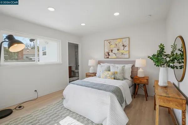 a bedroom with a bed and a potted plant