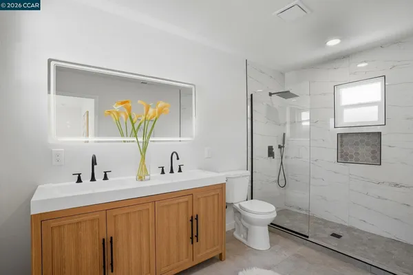 a bathroom with a toilet sink a shower and a mirror