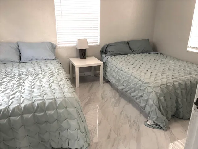 a bedroom with a bed and a night stand