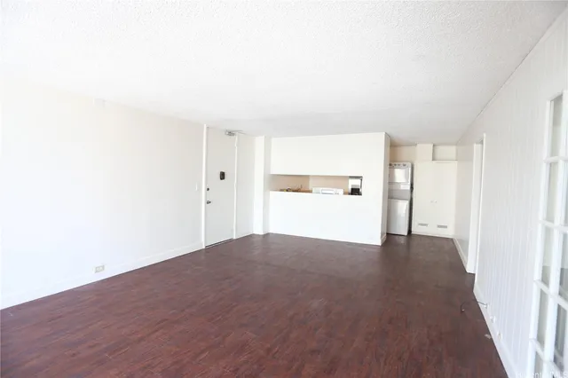 a view of a kitchen with a sink and a refrigerator
