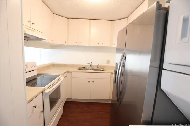 a kitchen with cabinets and stainless steel appliances