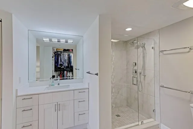 a bathroom with a shower sink and mirror