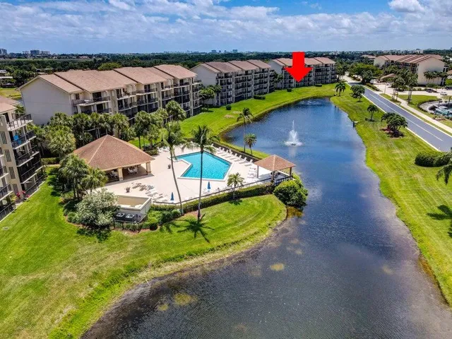 an aerial view of a house with a swimming pool patio and outdoor seating