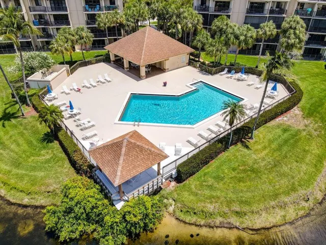 an aerial view of a house with a yard and swimming pool
