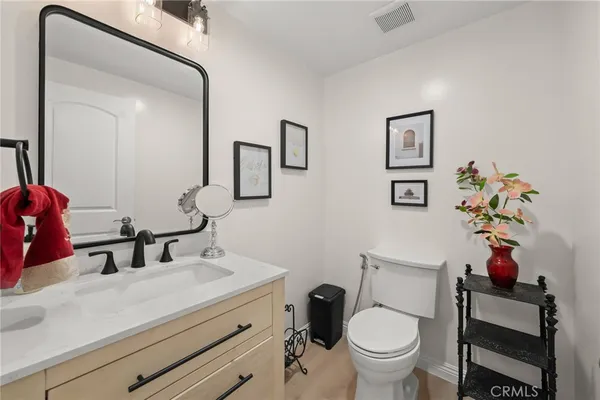 a kitchen with stainless steel appliances a dining table chairs and a refrigerator