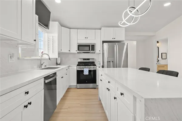 a large kitchen with a table and chairs