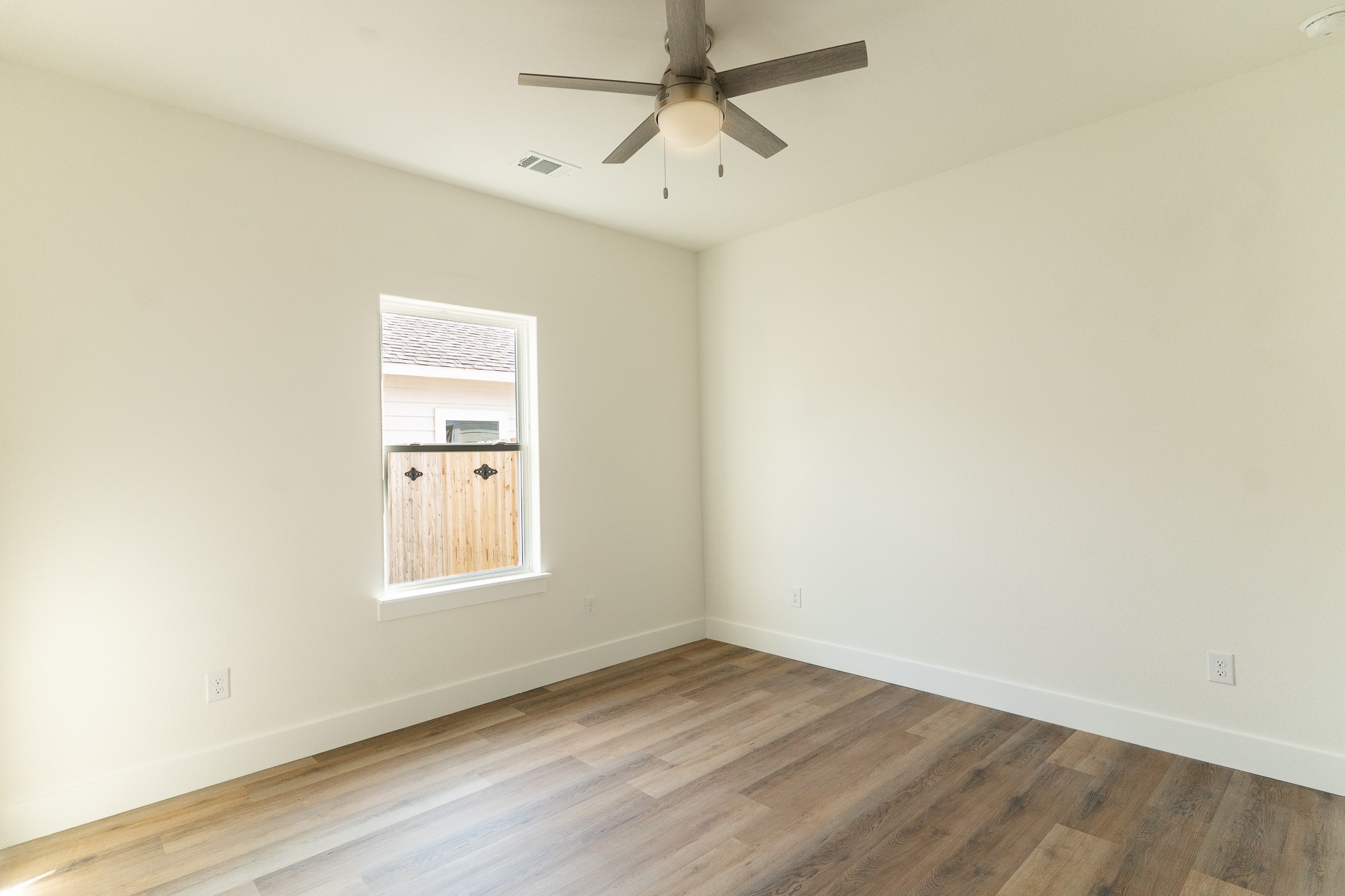 309 String Prairie Way Smithville, TX 78957 - Photo 24 of 30 an empty room with a window and a fan