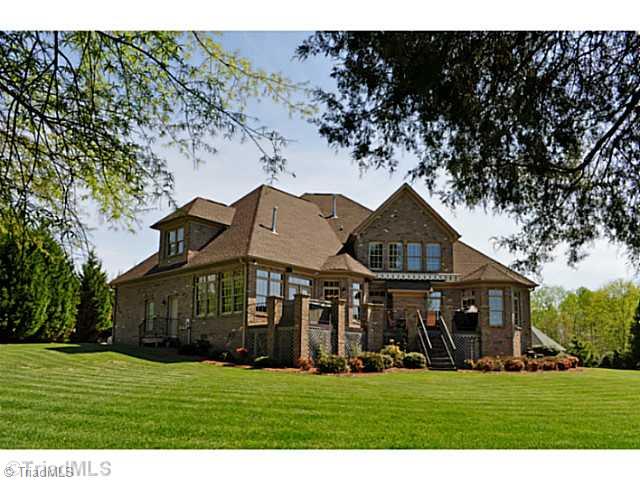 8401 Parkchester Place Oak Ridge, NC 27310 - Photo 13 of 16 Exterior Back. The back view of this gracious home shows off its large deck.