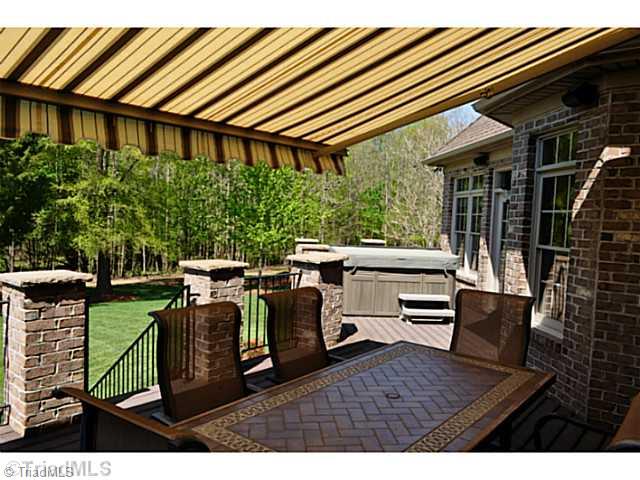 8401 Parkchester Place Oak Ridge, NC 27310 - Photo 14 of 16 Patio/Deck. The grand deck with its maintenance free composite flooring has more than enough room for a hot tub, grille & dining. The retractable sun shade is the perfect amenity.