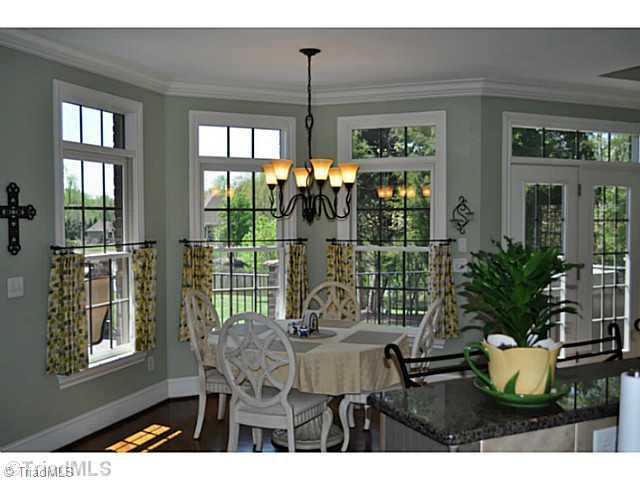 8401 Parkchester Place Oak Ridge, NC 27310 - Photo 5 of 16 Breakfast. This breakfast room has a great view of the lawn and pond.