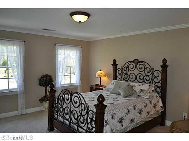 8401 Parkchester Place Oak Ridge, NC 27310 - Photo 9 of 16 2nd Bedroom. The second bedroom is very comfortably sized, and like all of the home s bedrooms has a big walk-in closet and an en suite full bath.