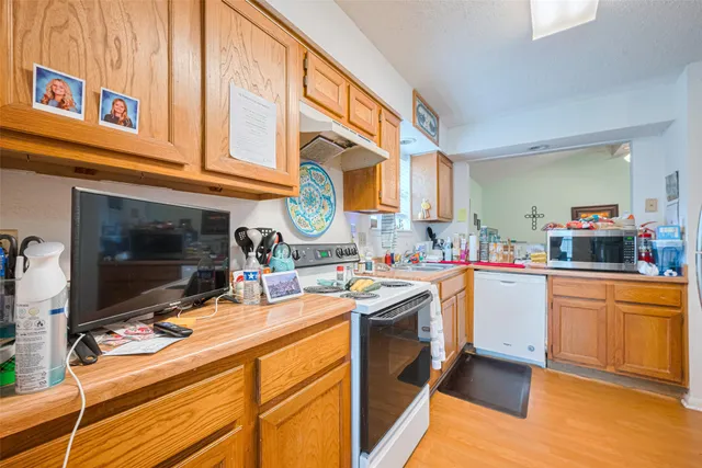 a kitchen with stainless steel appliances granite countertop a stove and a sink