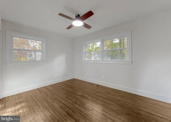 an empty room with a empty space and windows