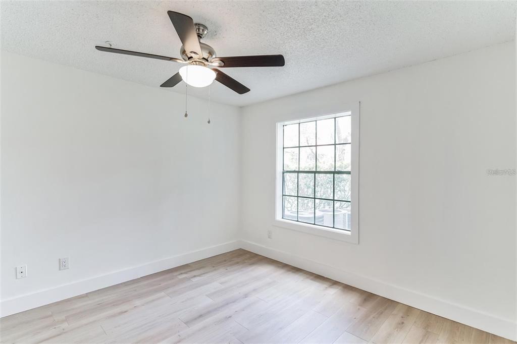 241 Afton Square, Unit 102 Altamonte Springs, FL 32714 - Photo 6 of 12 an empty room with window and ceiling fan