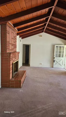 a view of an empty room with a fireplace