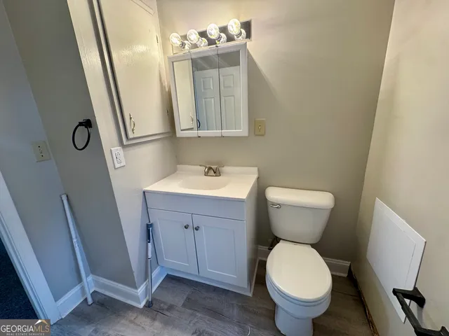 a bathroom with a sink toilet and mirror