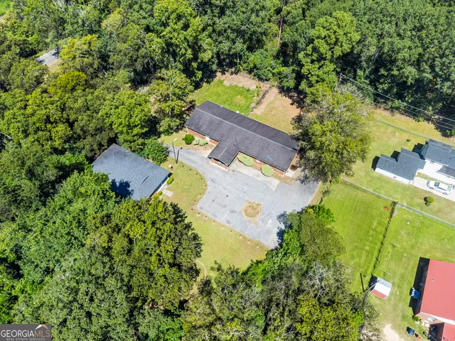 an aerial view of a house with a yard