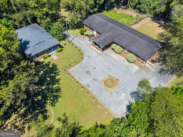 an aerial view of a house with a swimming pool