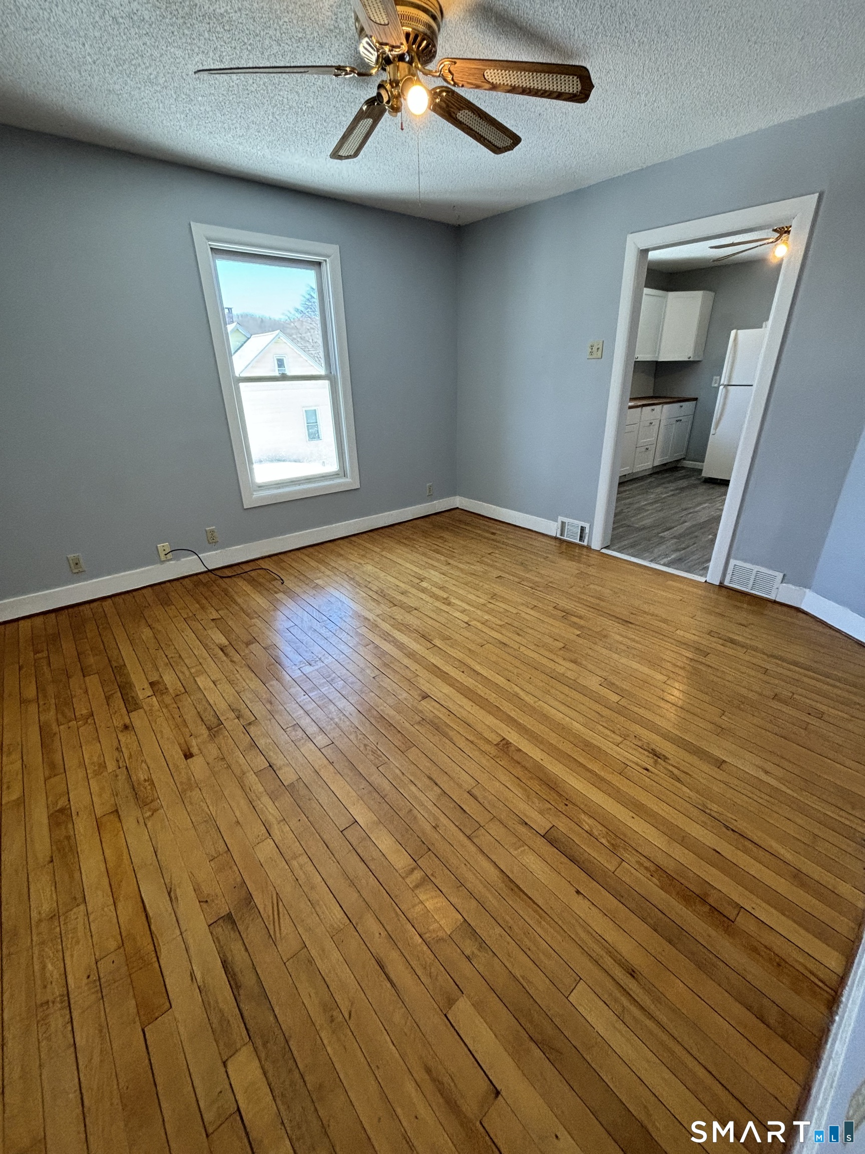 11 Roberts Street, Unit 2 Bristol, CT 06010 - Photo 6 of 11 wooden floor in an empty room with a window