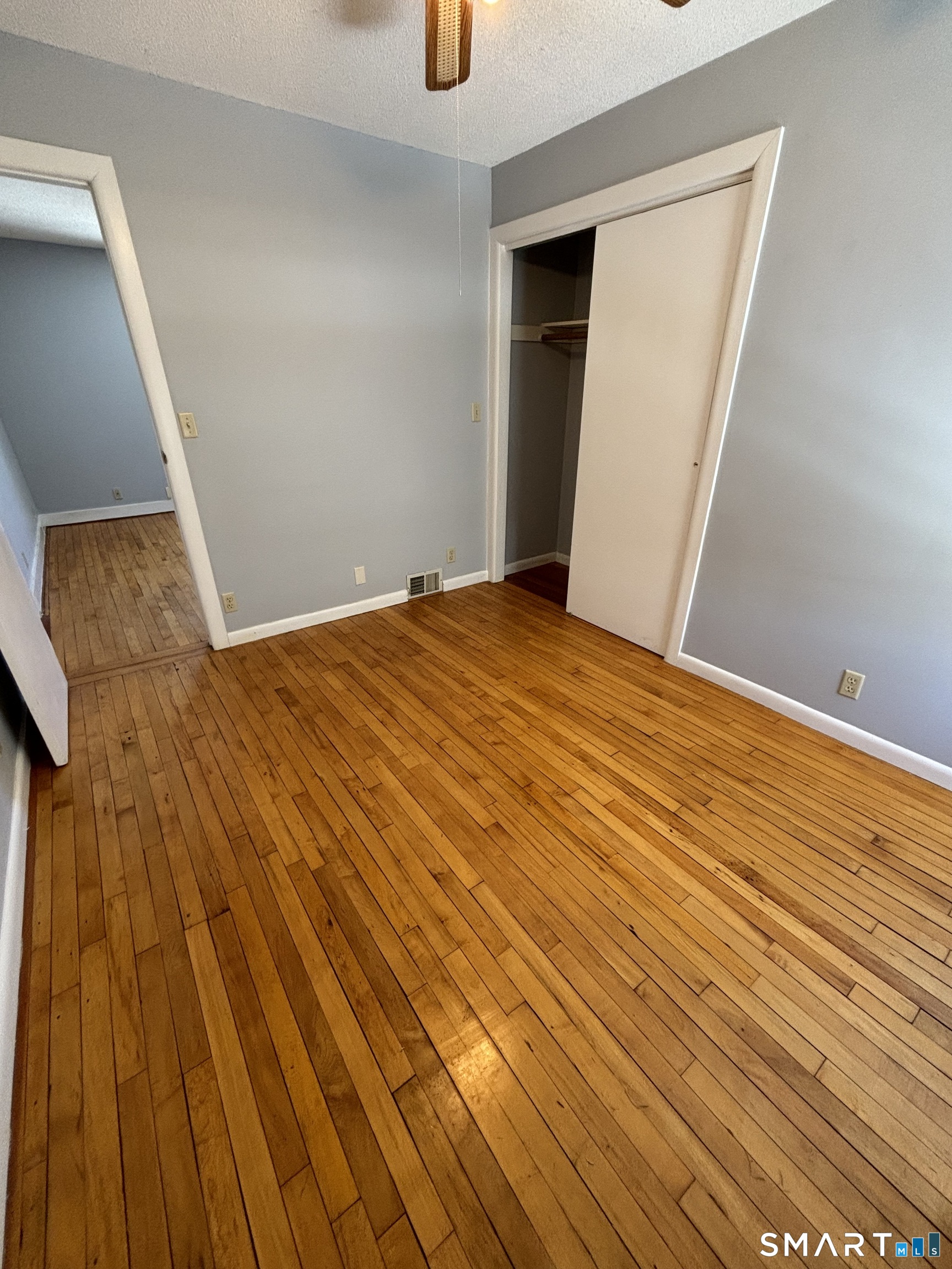 11 Roberts Street, Unit 2 Bristol, CT 06010 - Photo 7 of 11 a view of empty room with wooden floor