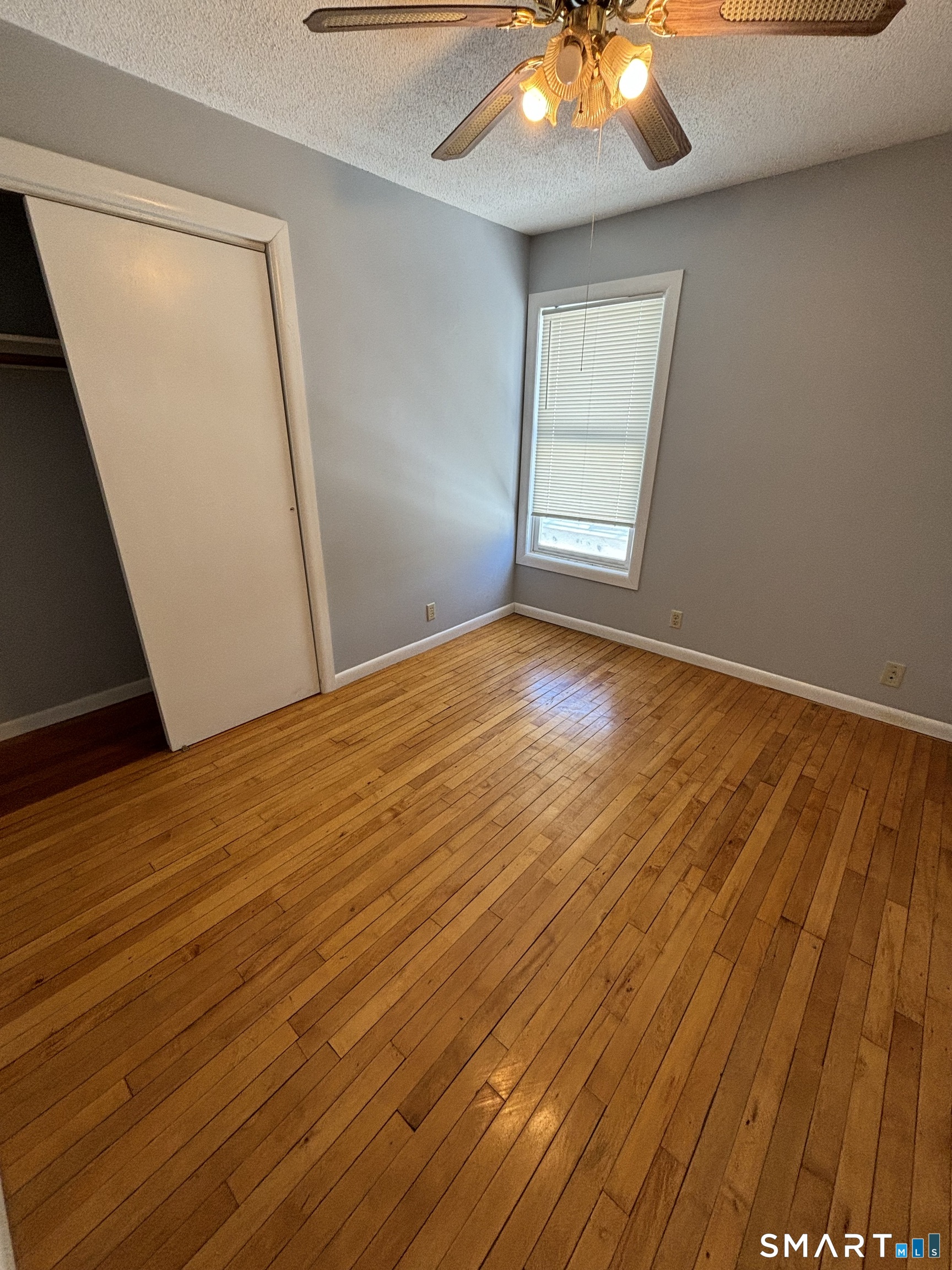 11 Roberts Street, Unit 2 Bristol, CT 06010 - Photo 8 of 11 wooden floor in an empty room with a window