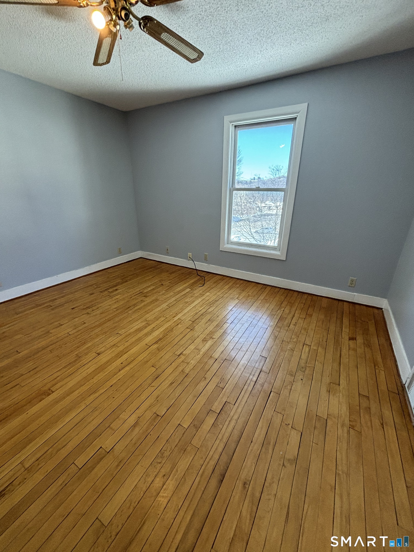 11 Roberts Street, Unit 2 Bristol, CT 06010 - Photo 9 of 11 a view of empty room with wooden floor