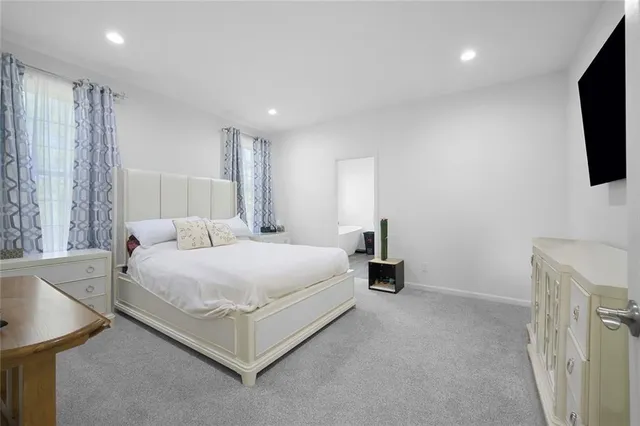 a bedroom with a bed and flat screen tv