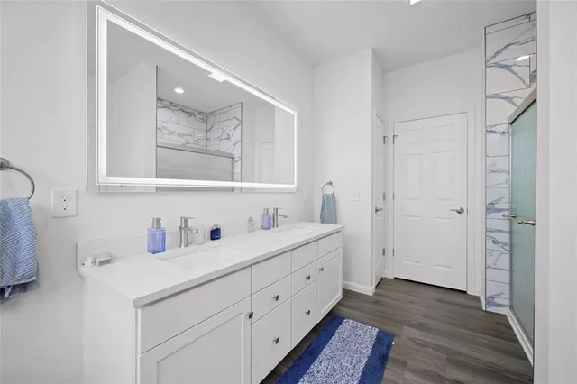 a bathroom with a double vanity sink mirror and