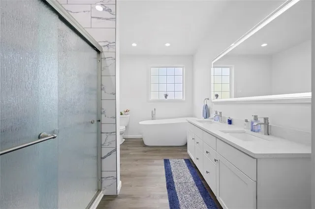 a bathroom with a double vanity sink mirror and shower