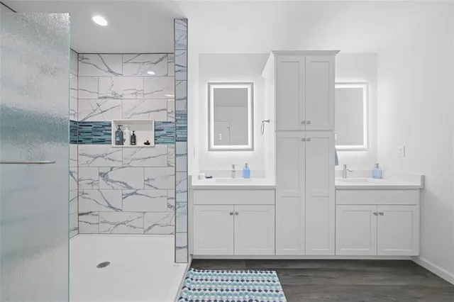 a bathroom with a sink a toilet and a mirror