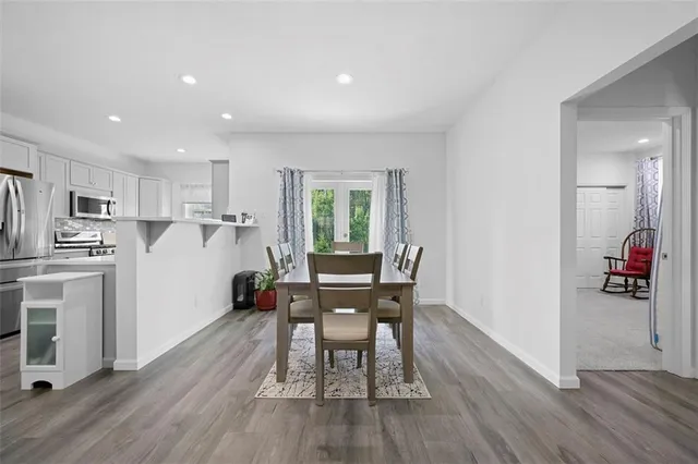 a view of a dining room with furniture and wooden floor