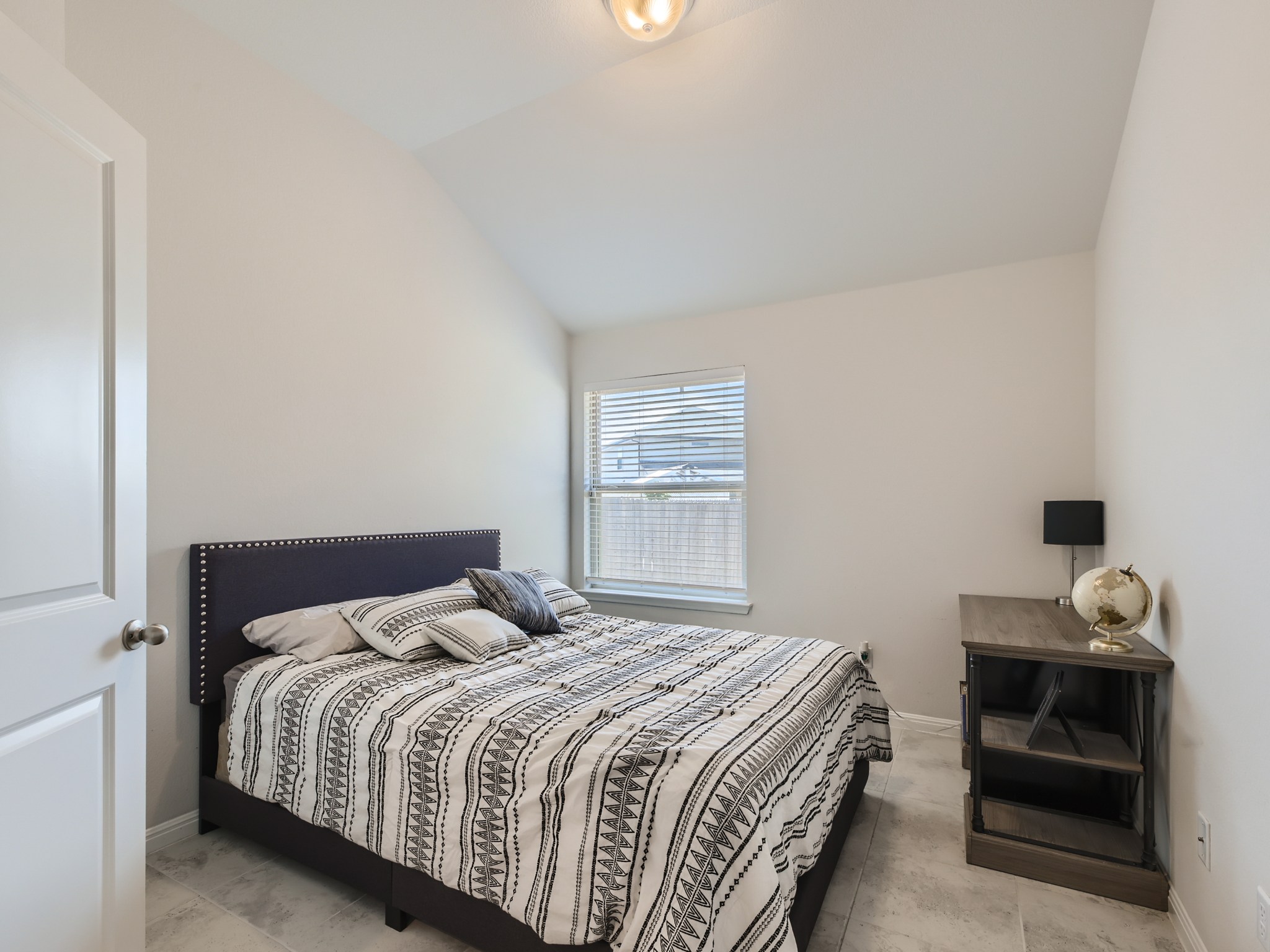 195 Star Light Way Kyle, TX 78640 - Photo 12 of 29 a bedroom with a bed and a window