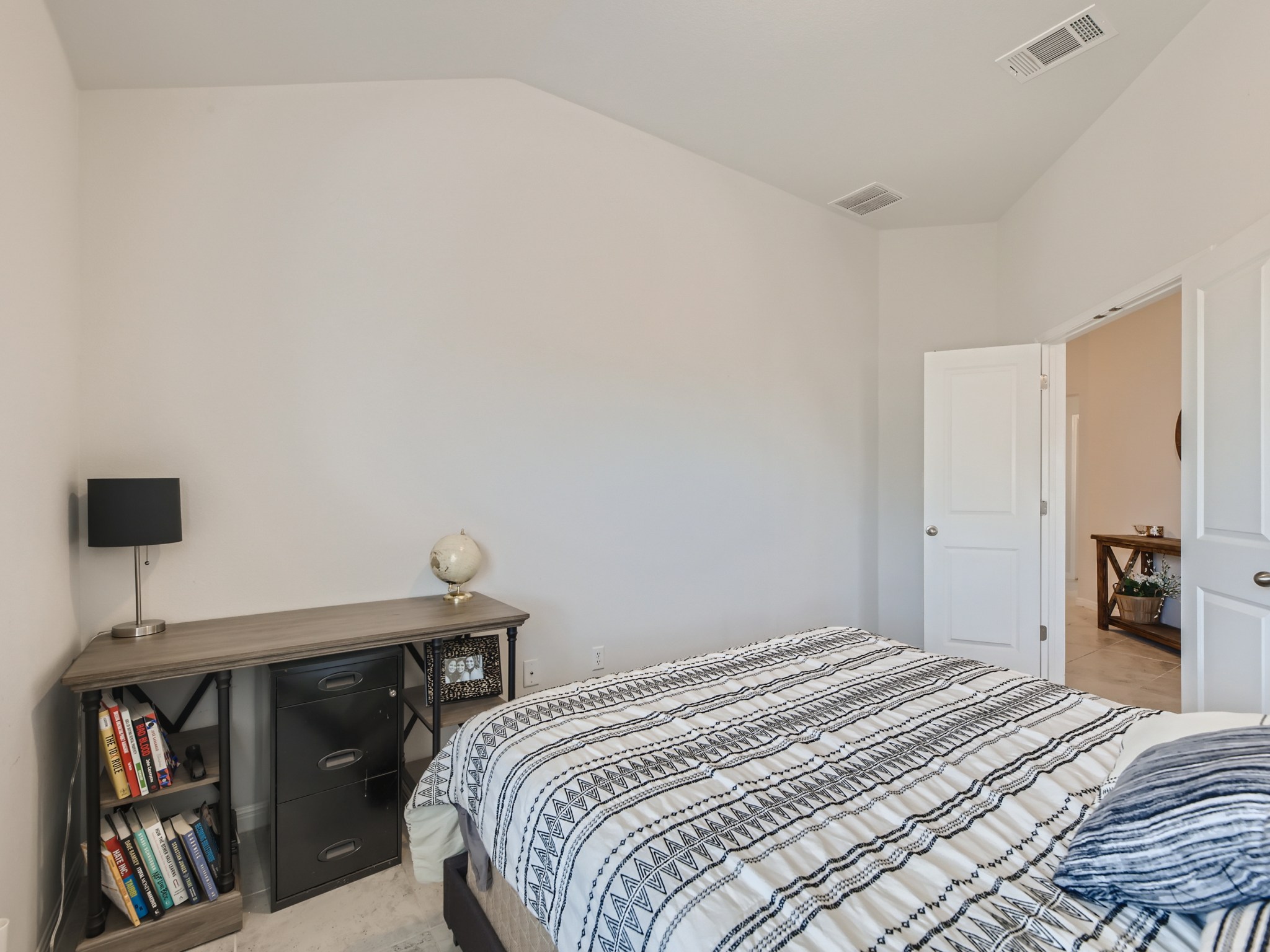 195 Star Light Way Kyle, TX 78640 - Photo 13 of 29 a bedroom with a bed and a book shelf