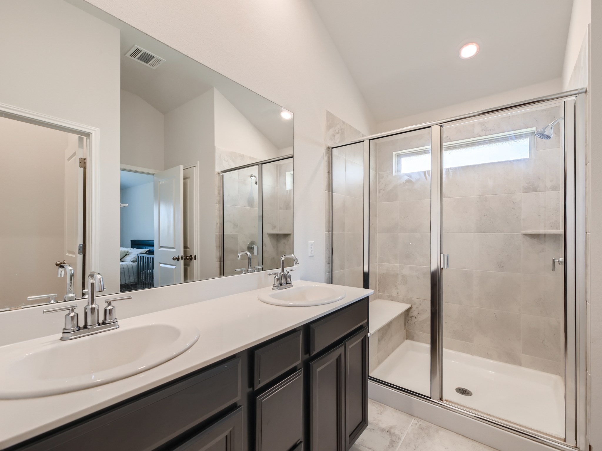 195 Star Light Way Kyle, TX 78640 - Photo 17 of 29 a bathroom with a double vanity sink mirror and shower