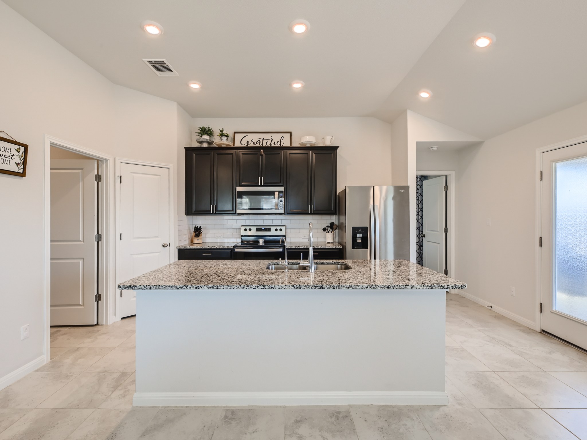 195 Star Light Way Kyle, TX 78640 - Photo 8 of 29 a large kitchen with stainless steel appliances granite countertop a granite counter tops and a refrigerator