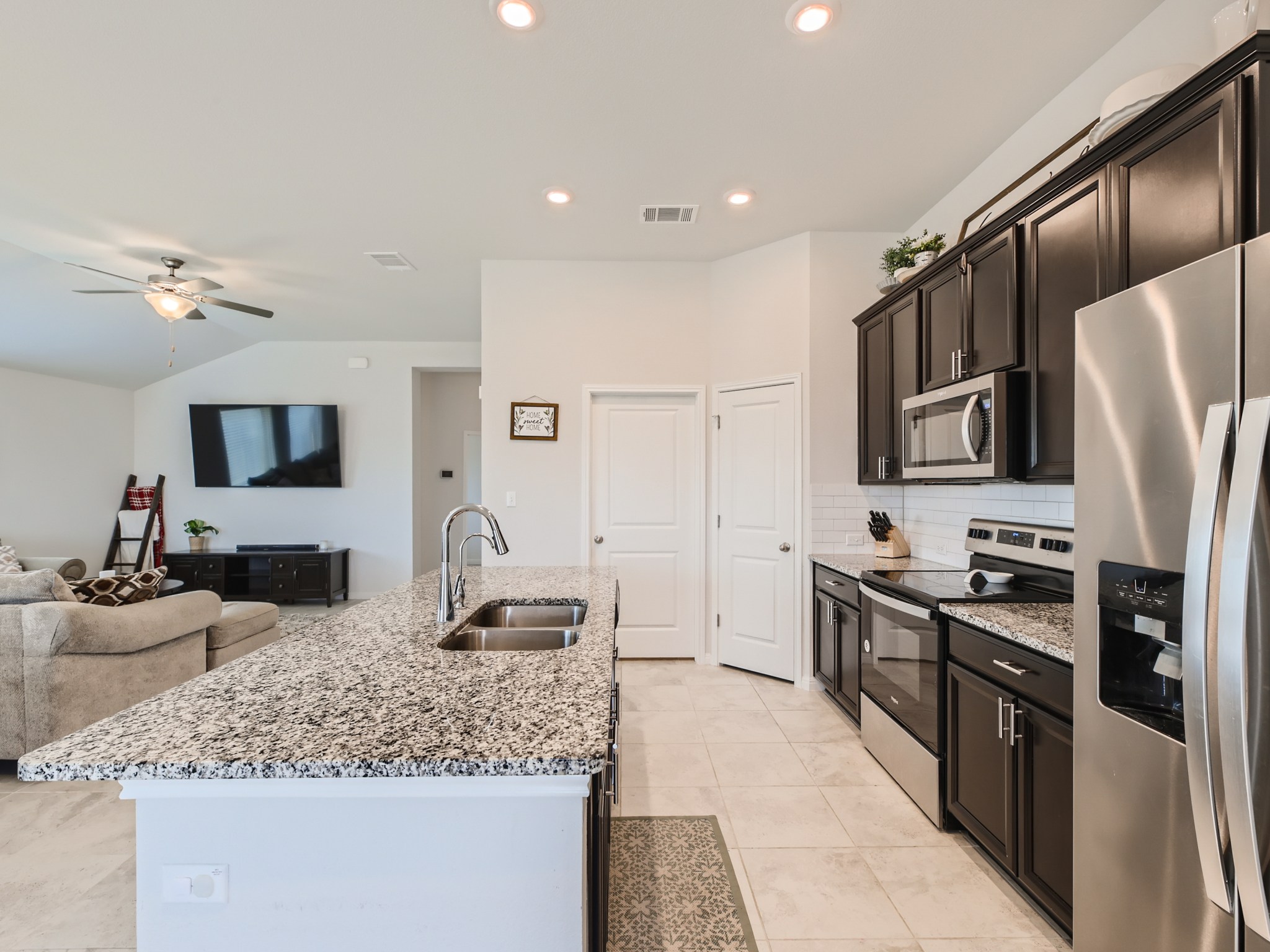 195 Star Light Way Kyle, TX 78640 - Photo 9 of 29 a kitchen with stainless steel appliances granite countertop a sink stove and refrigerator