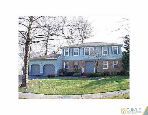 26 Churchill Road Edison, NJ 08820 - Photo 1 of 13 a front view of a house with a garden and trees