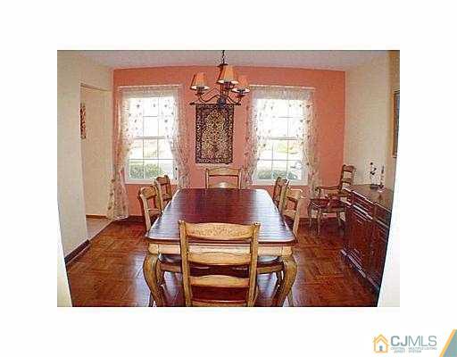 26 Churchill Road Edison, NJ 08820 - Photo 3 of 13 a living room with furniture a window and dining table