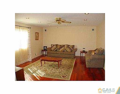 26 Churchill Road Edison, NJ 08820 - Photo 7 of 13 a living room with a couch and a potted plant