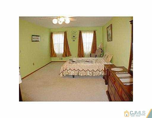 26 Churchill Road Edison, NJ 08820 - Photo 8 of 13 a living room with a bed