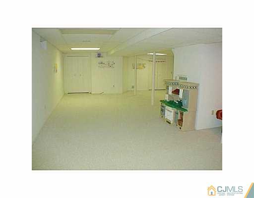 26 Churchill Road Edison, NJ 08820 - Photo 10 of 13 a open hall with a bench