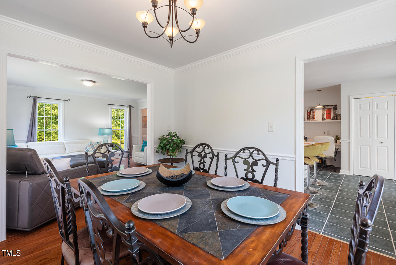 135 Deep Creek Rougemont, NC 27572 - Photo 11 of 72 a dining room with furniture a chandelier and wooden floor