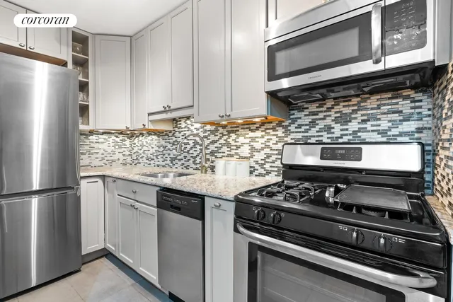 a kitchen with granite countertop cabinets and steel stainless steel appliances