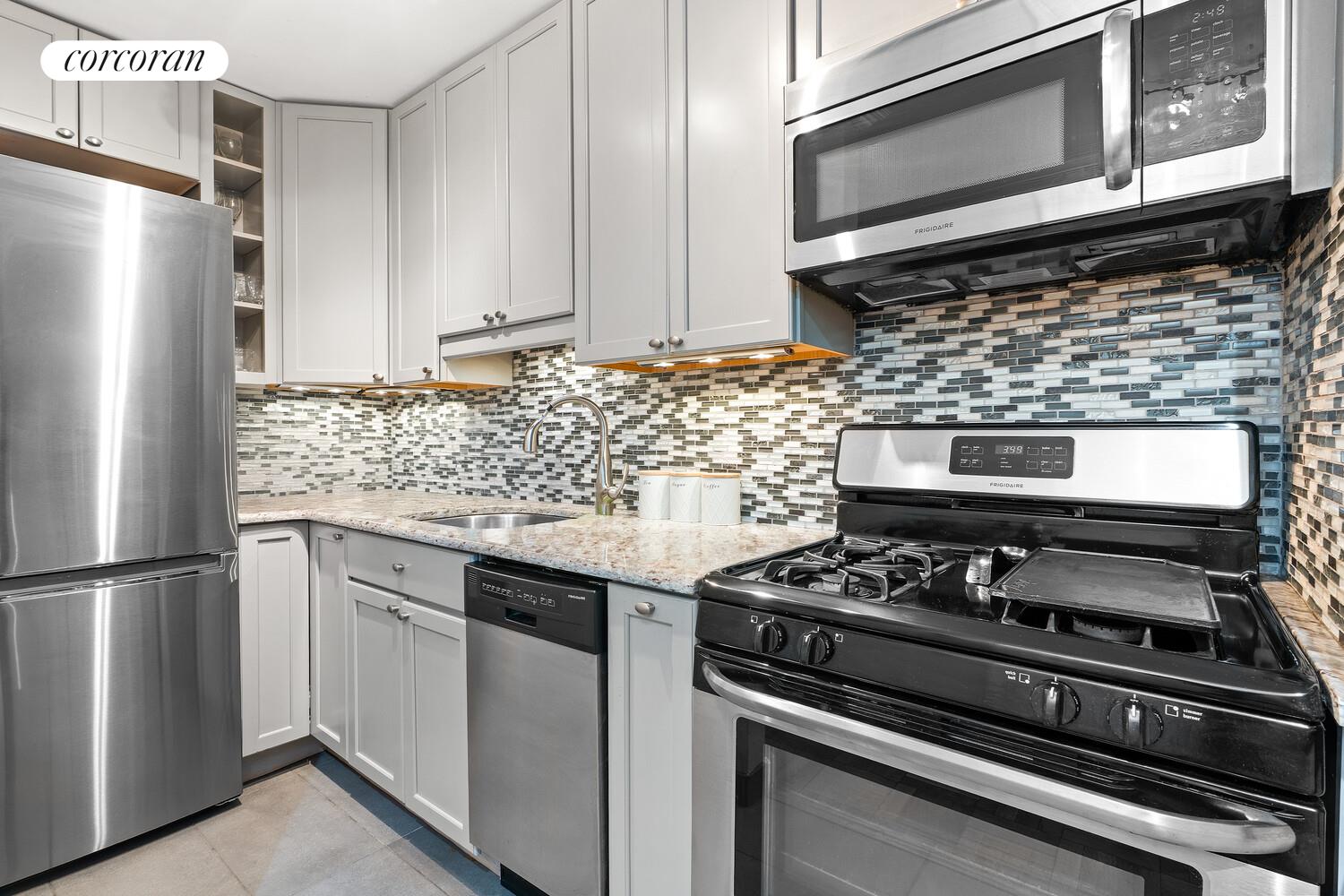 a kitchen with granite countertop cabinets and steel stainless steel appliances
