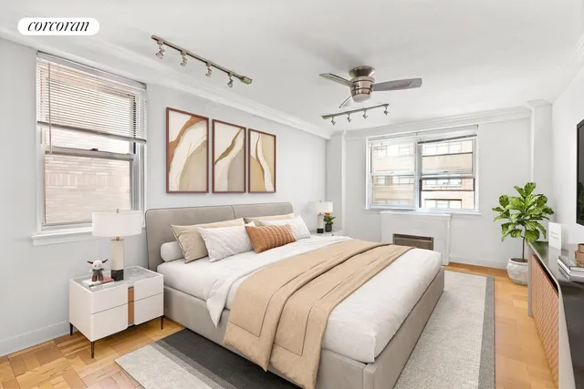 a bedroom with a large bed and a chandelier