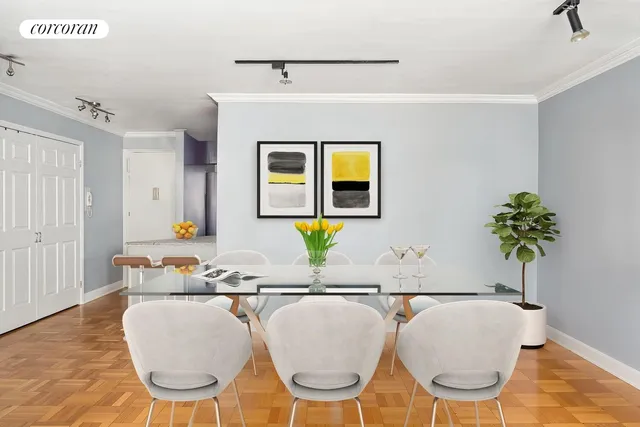 a living room with a couch and paintings on the wall