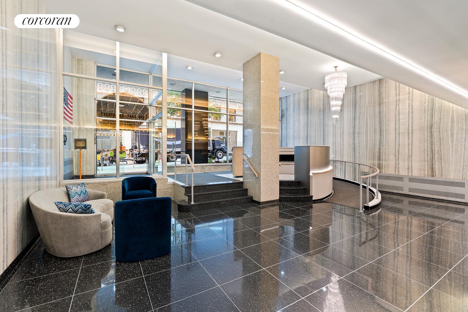 139 East 33rd Street, Unit 7L Manhattan, NY 10016 - Photo 6 of 11 a living room with fireplace furniture and a large window